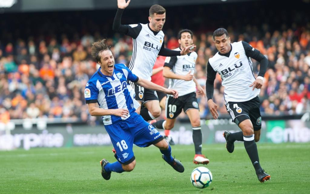 Jose Luis Gaya and Jesion Murillo of Valencia CF and Tomas Pina of Alaves