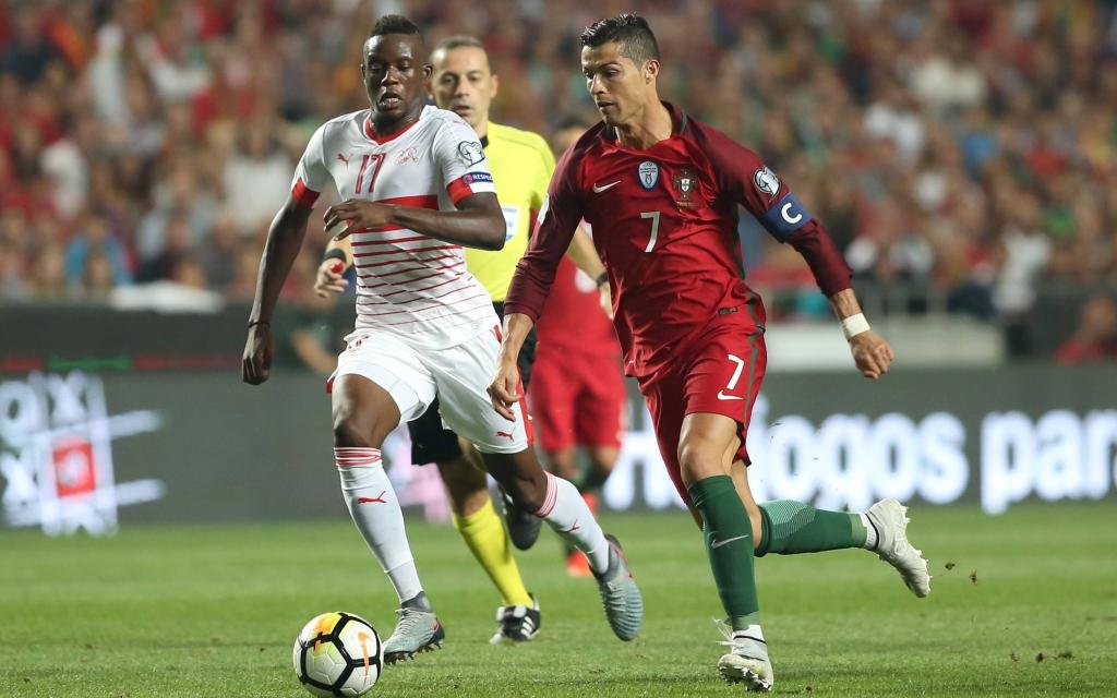 October 10, 2017 - Lisbon, Portugal - Portugal s forward Cristiano Ronaldo (L) vies with Switzerland s midfielder Denis Zakaria during the 2018 FIFA World Cup WM Weltmeisterschaft Fussball qualifying football match