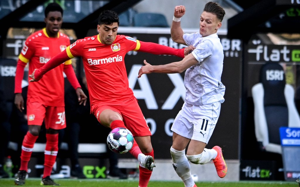 210307 -- MOENCHENGLADBACH, March 7, 2021 -- Nadiem Amiri L of Leverkusen vies with Hannes Wolf of Moenchengladbach during a German Bundesliga football match between Borussia Moenchengladbach and Bayer 04 Leverkusen in Moenchengladbach, Germany, March 6, 2021