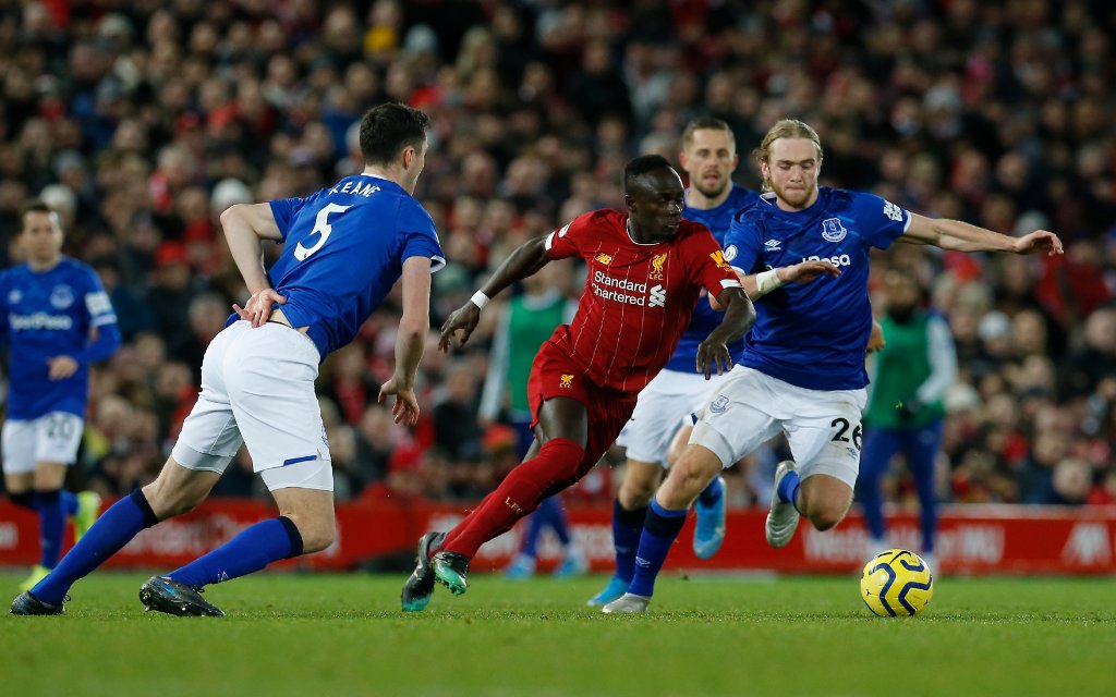 Football - 2019 / 2020 Premier League - Liverpool vs. Everton Sadio Mane of Liverpool goes past Tom Davies and Michael Keane of Everton